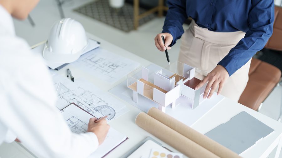 Engineers reviewing architectural blueprints